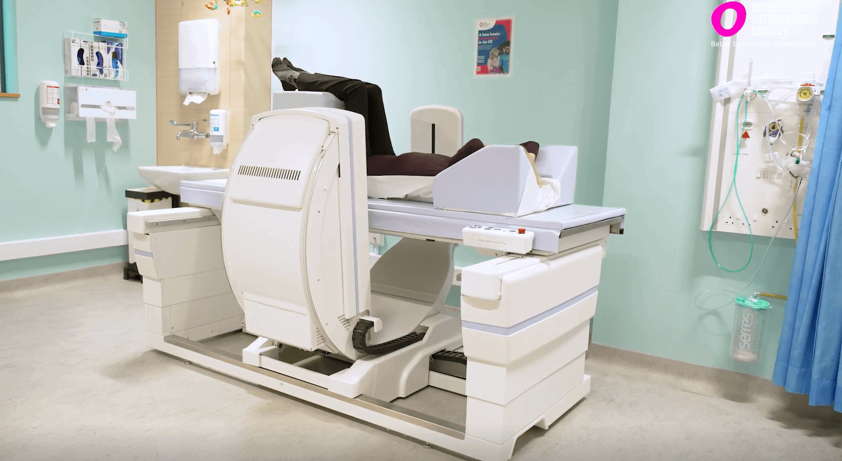 Woman lying on a bone density scanning machine