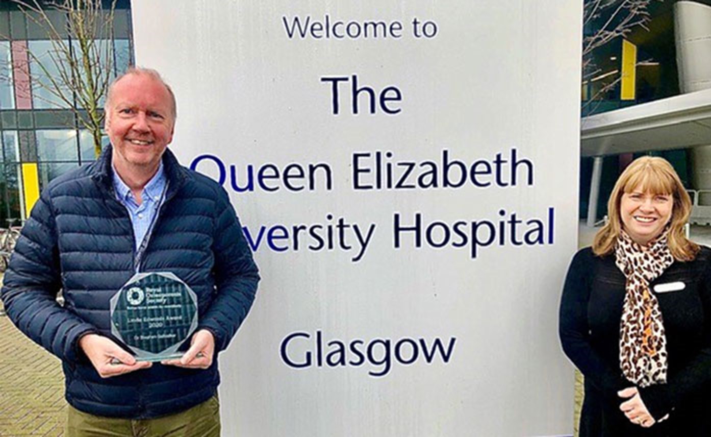 Above: Dr Stephen Gallacher receiving the Linda Edwards Award by ROS Service Development Lead in Scotland Mayrine Fraser outside Queen Elizabeth University Hospital Glasgow.