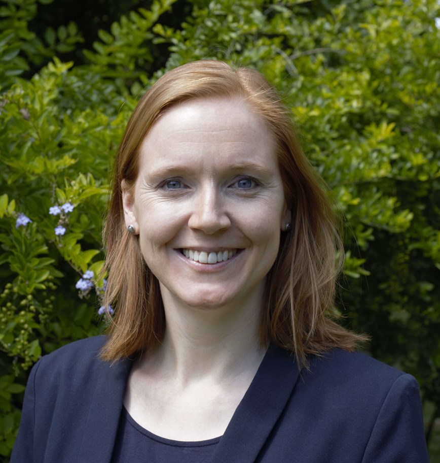 Picture of Celia Gregson, a woman with red hair in a navy blazer