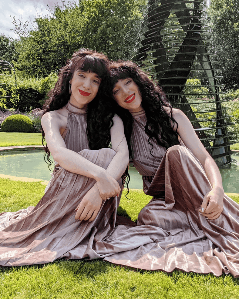 Twin singers 'Classical Reflection' sitting outside