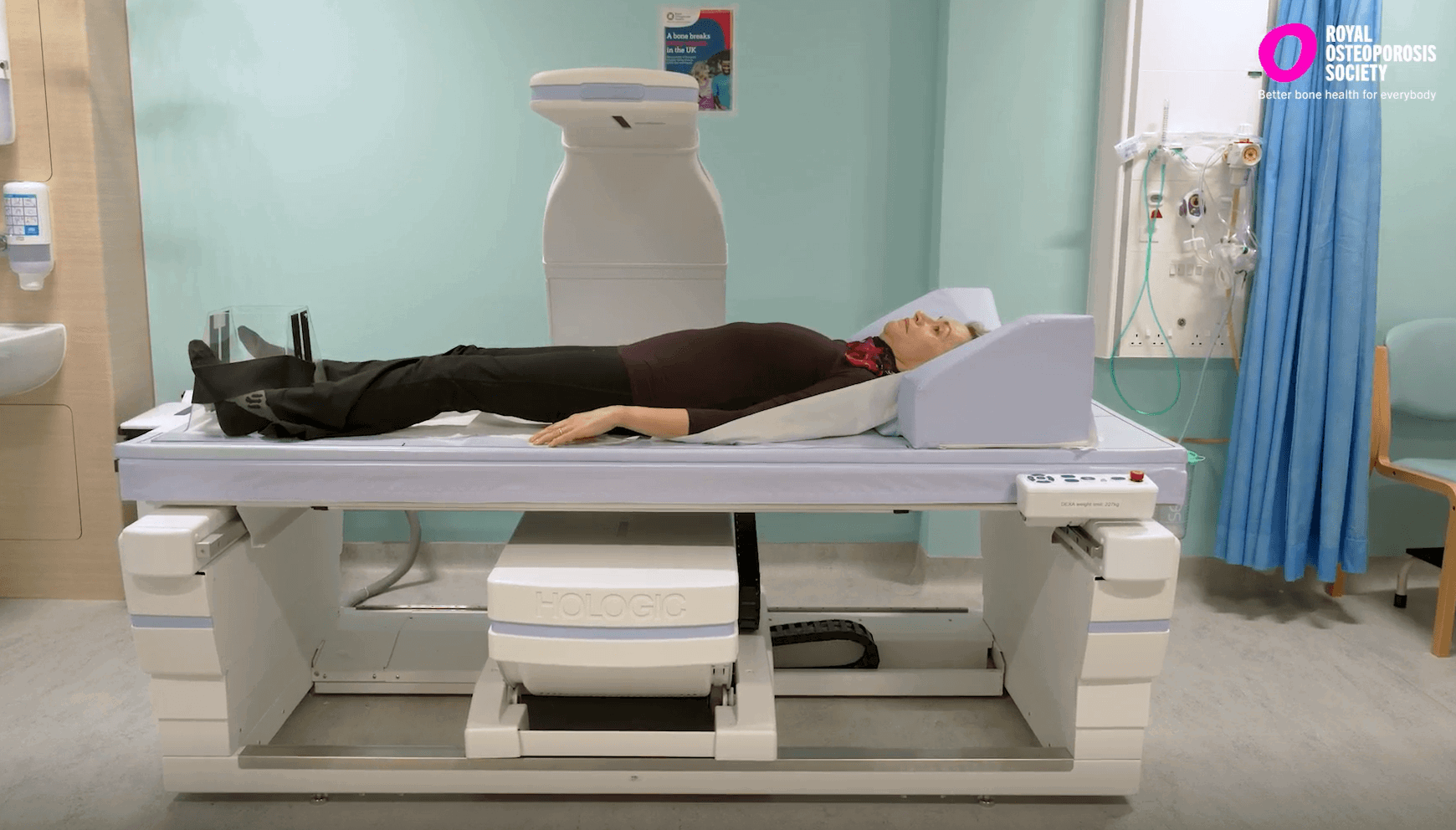 Woman lying in a bone density scanning machine