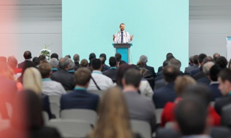 Male Doctor Giving A Speech On A Podium At A Conference