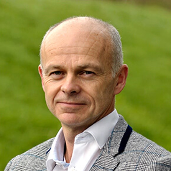 Picture of Neil Gittoes, a man in a shirt and grey blazer