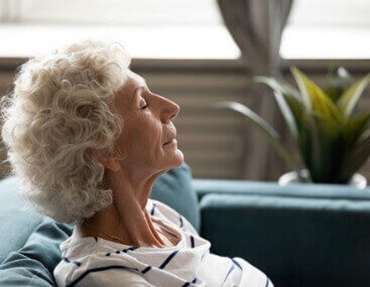 Mature Calm Woman Closed Eyes Enjoy Fresh Air Indoors