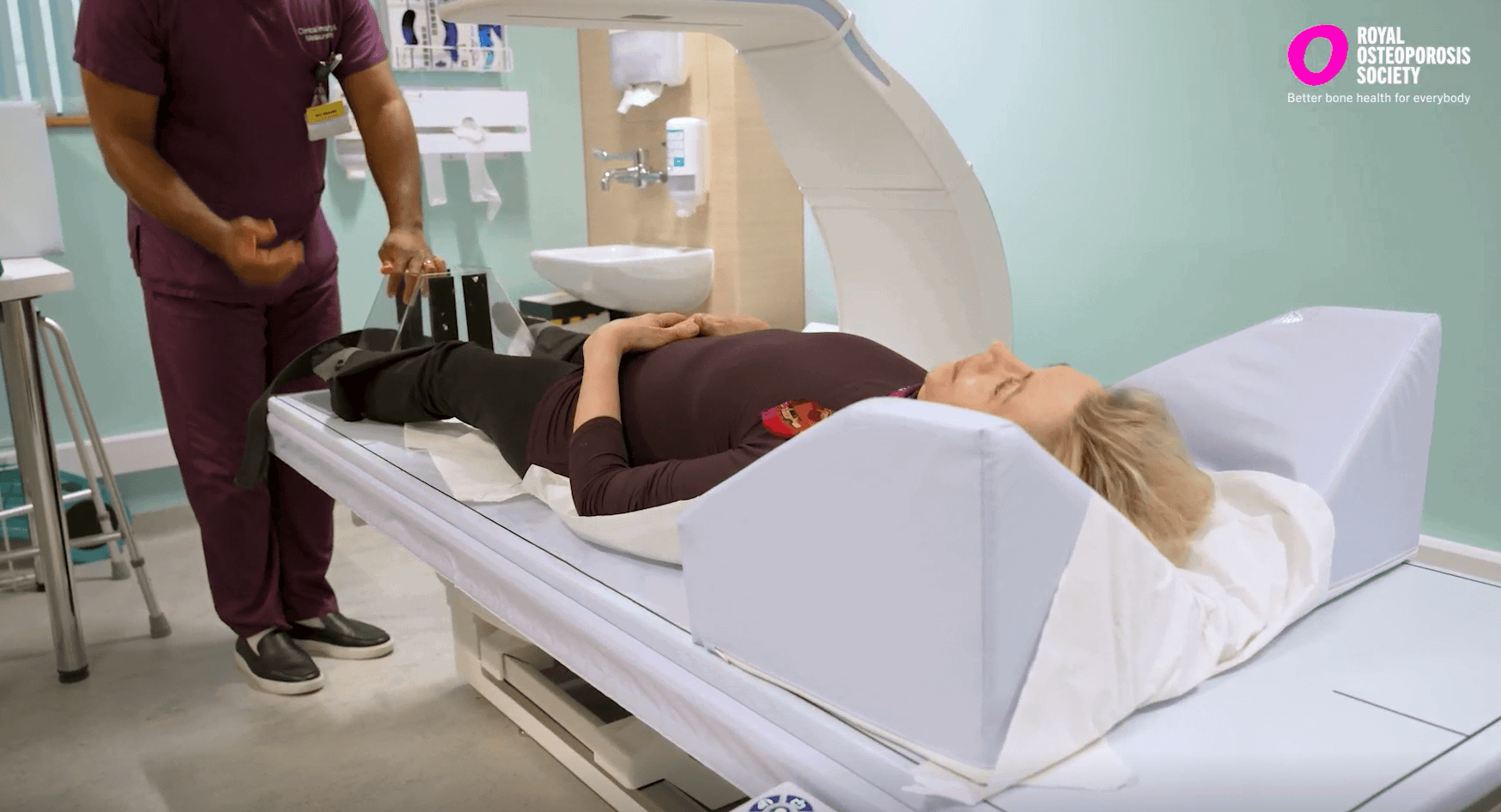 Women lying down about to have a bone density scan in hospital