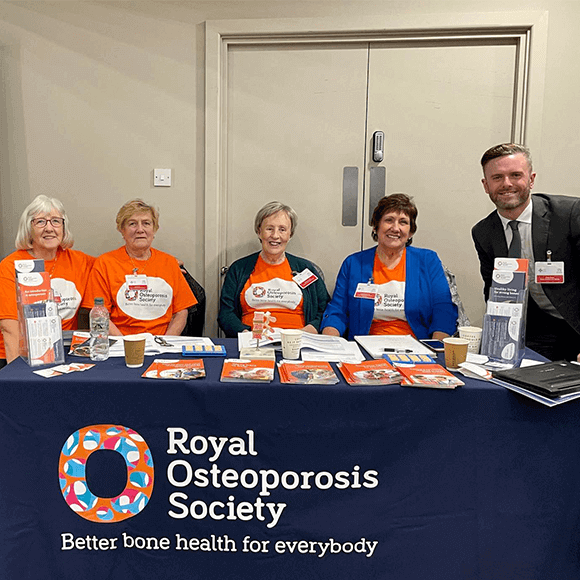 ROS CEO, Craig Jones standing next to four ROS volunteers on a stand at the FLS conference in Wales