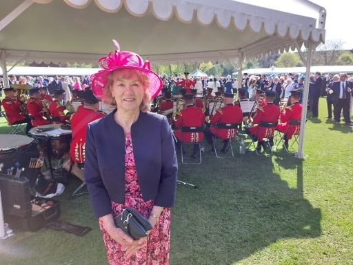 Volunteer Jan standing outside at the garden party at Buckingham Palace