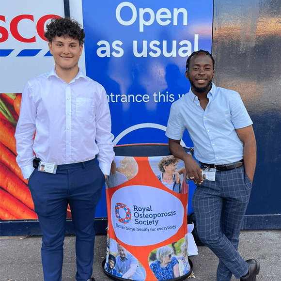 Two face-to-face fundraisers standing outside Tesco's with an ROS stand