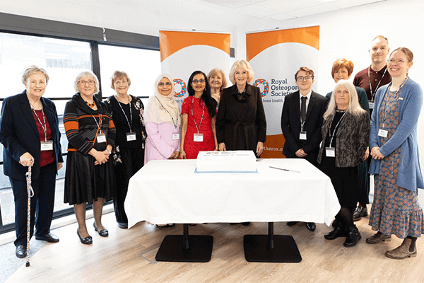 Her Majesty The Queen Consort standing with volunteers