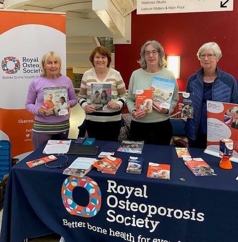 four ROS volunteers stood behind a table holding up leaflets