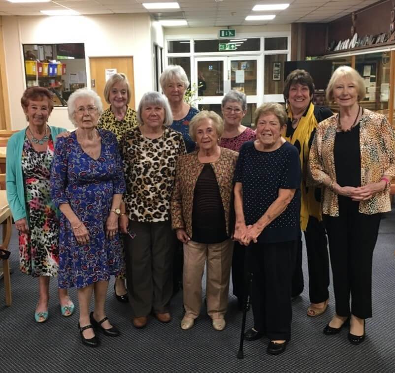 A group of ladies stand together