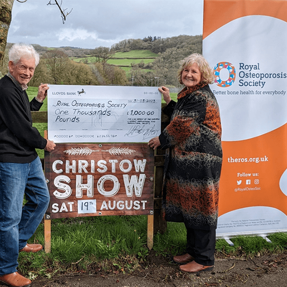 Two ROS volunteers receiving a cheque for the charity